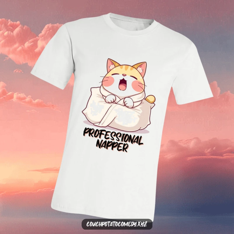 Funny t-shirt featuring a round cat in a comfy robe, yawning widely while draped over a large pillow, celebrating comfort and sleep.